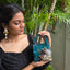 Feather saga evil eye mini bag emerald green styled for festive wear