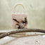 Feather saga evil eye mini bag in ivory white with feather embellishments