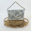 Flaura Bag in silver hand-embroidered envelope style bag